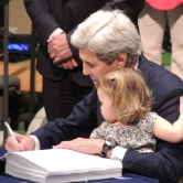 John Kerry and his Granddaughter signing the treaty for the US